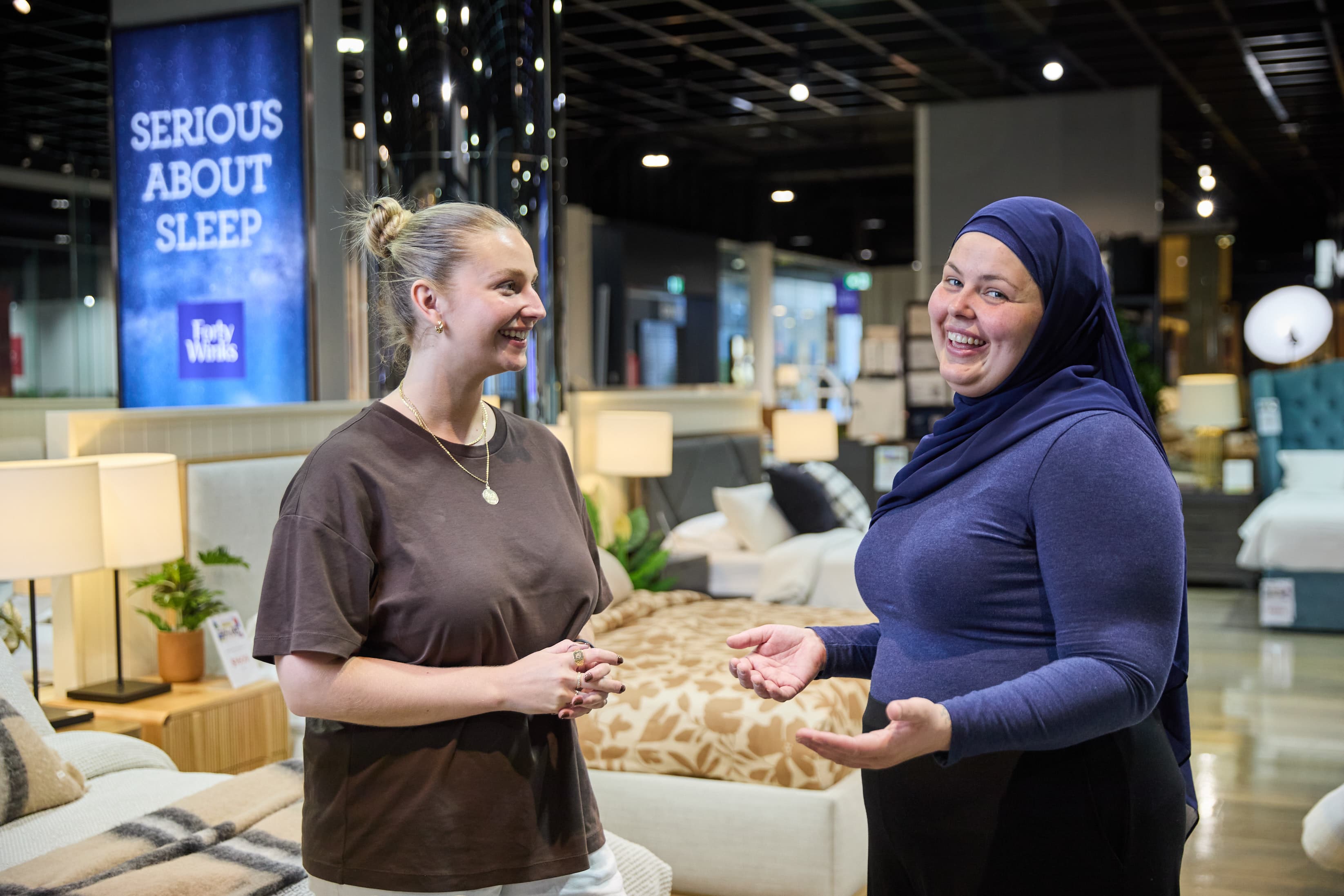 Customer talking with a Forty Winks team member in the showroom.