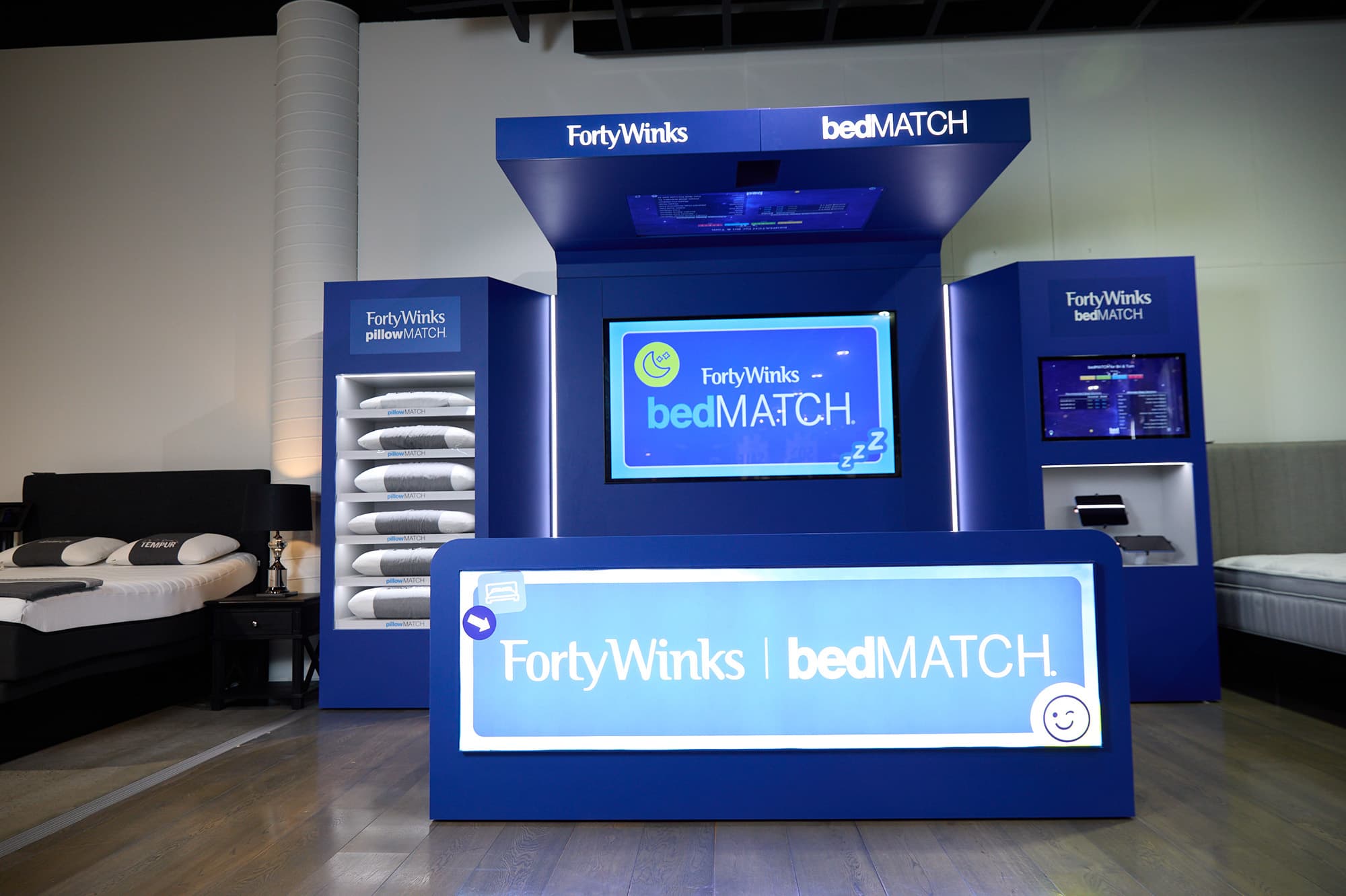 A Forty Winks customer trying a mattress in store