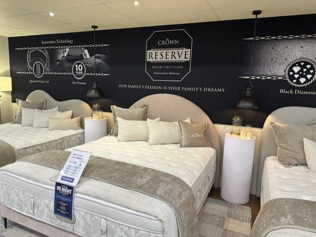 A Forty Winks customer trying a mattress in store
