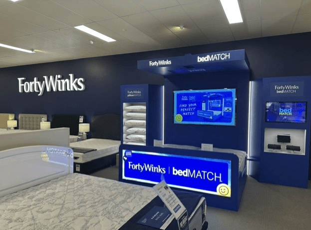 A Forty Winks team member helping a customer in store
