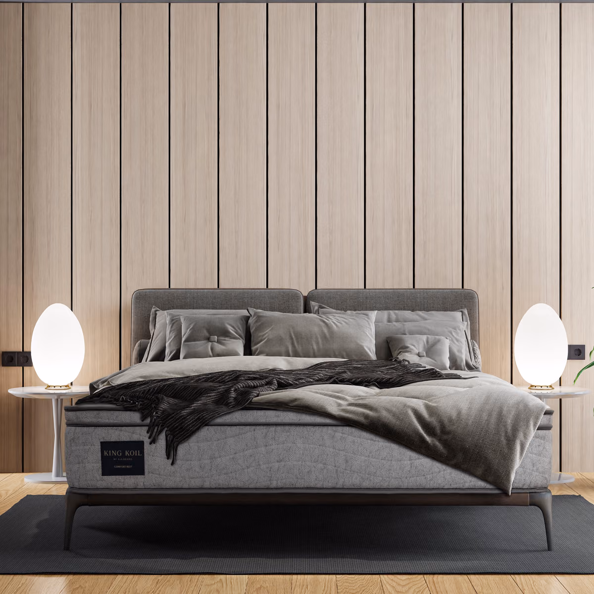 King Koil mattress on a grey bed in a modern bedroom.