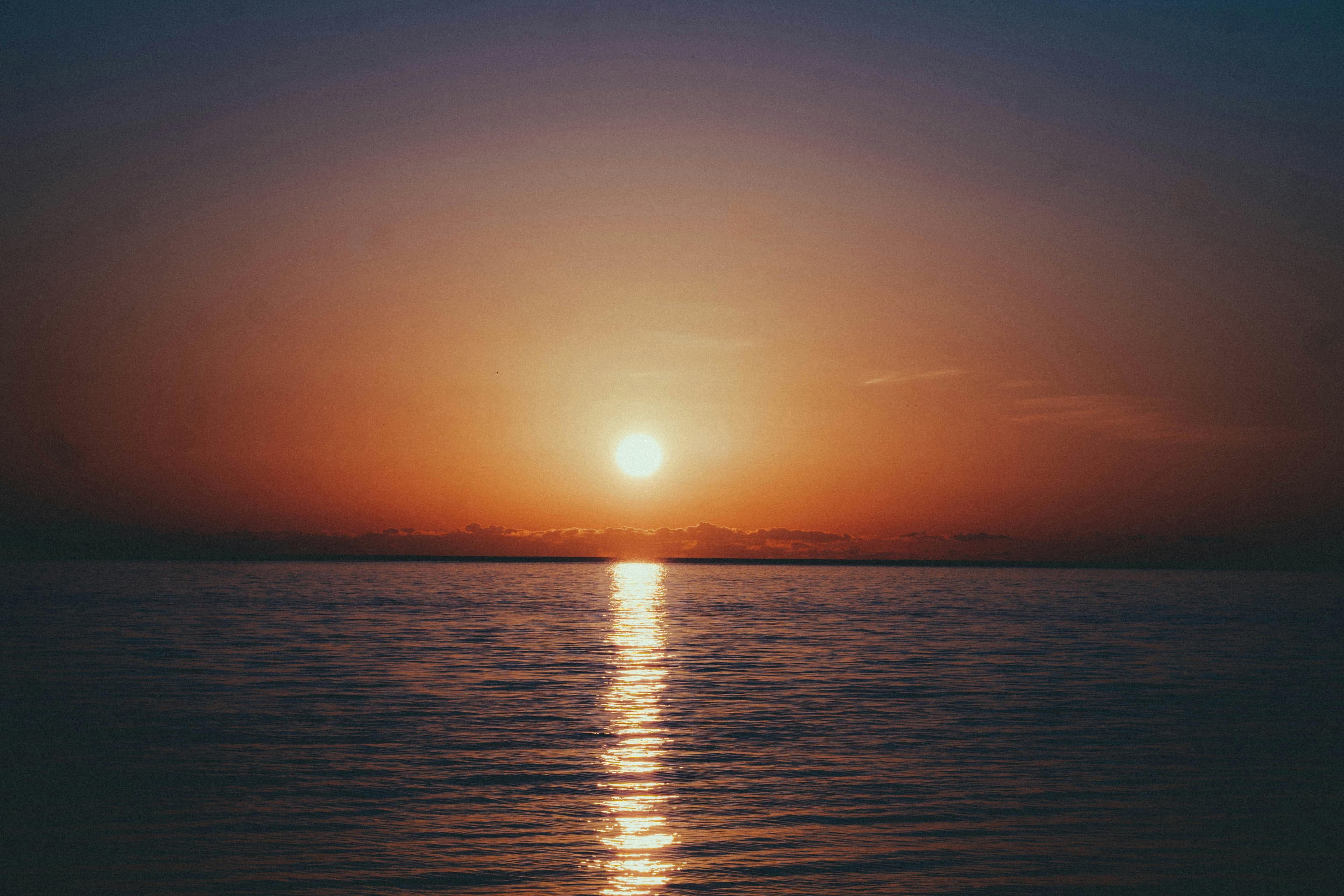 Sun setting over the ocean.