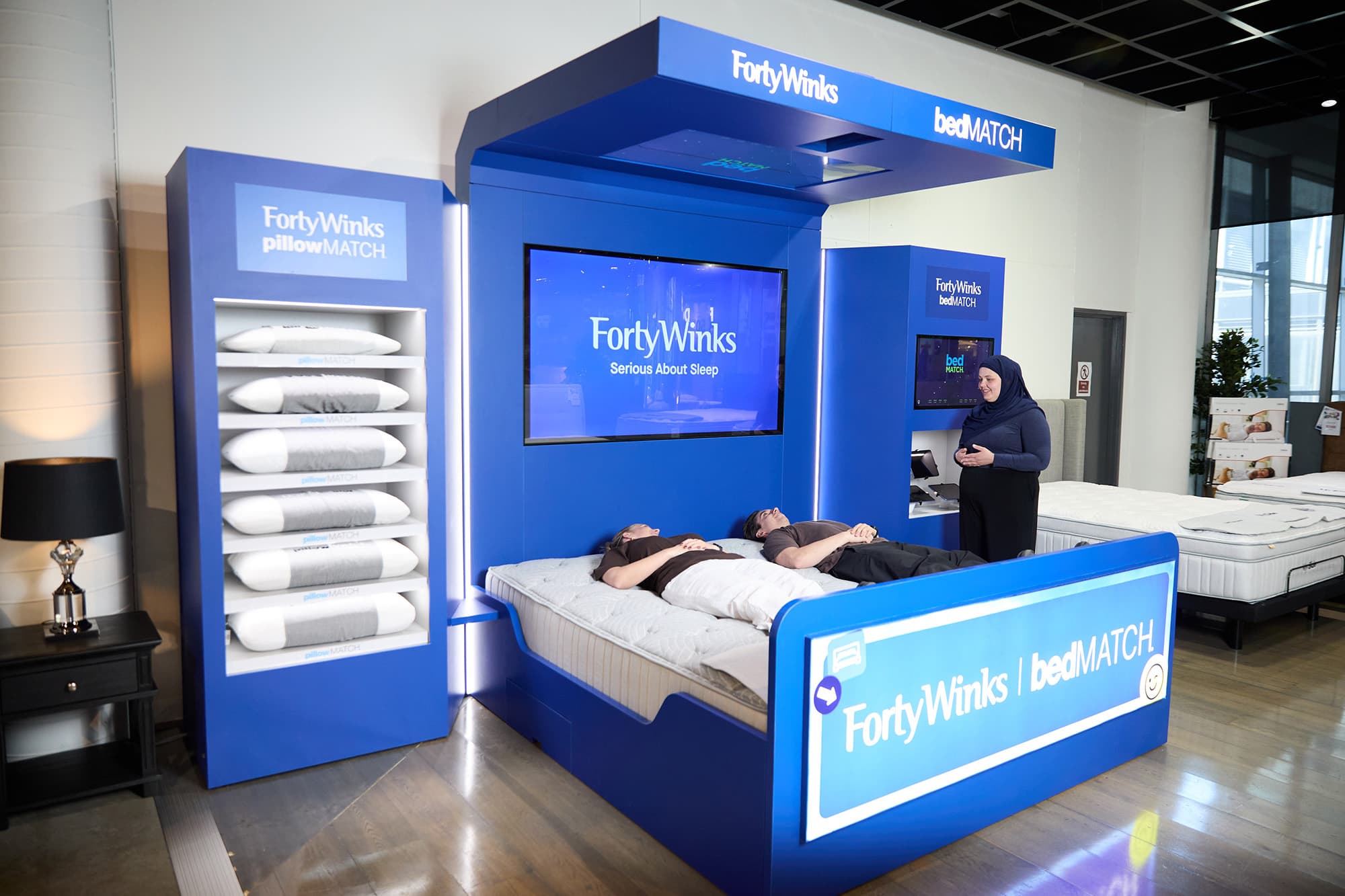 A trusted Forty Winks Sleep Advisor helping customers choose a mattress in store