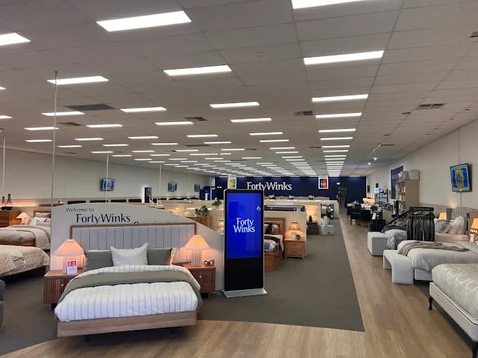 Forty Winks showroom with made-up beds on display.