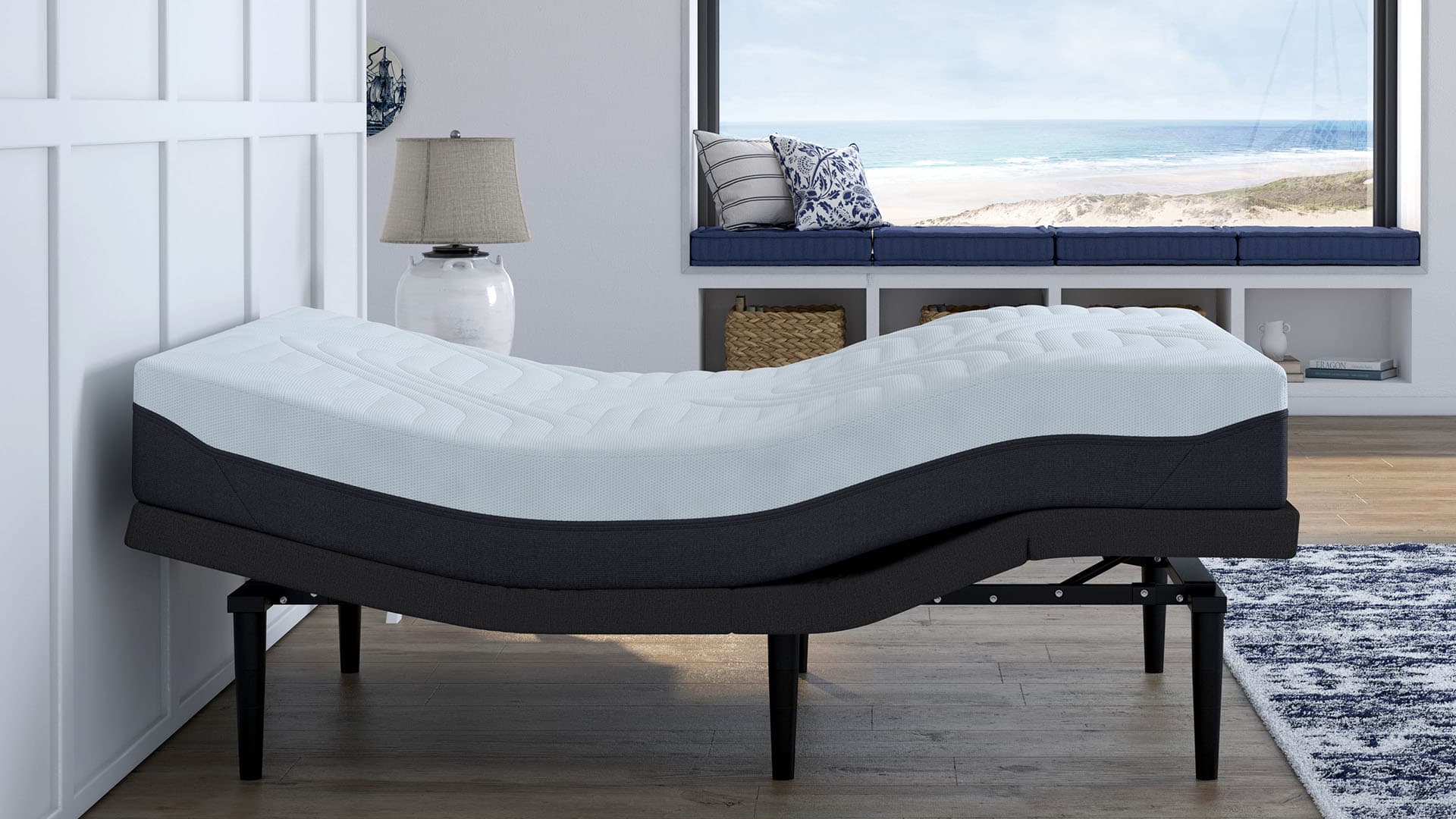 Adjustable bed raised into a zero-gravity position beside a beach-view window.