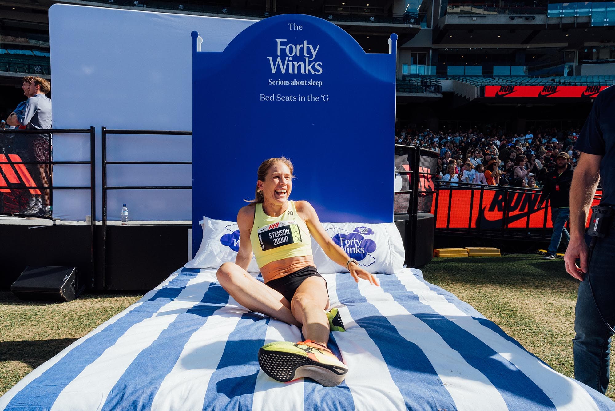 Marathon runner relaxing on the Forty Winks bed at the MCG.