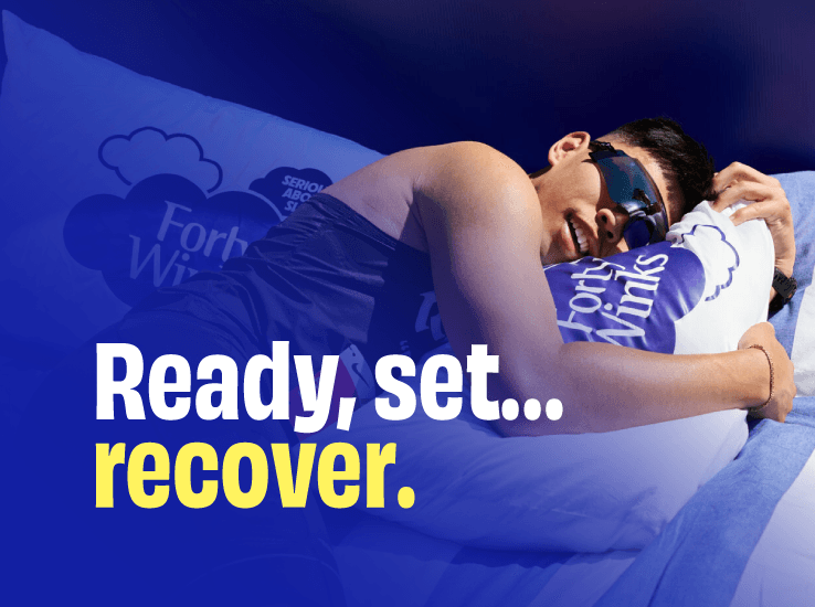 A runner asleep in bed wearing a sleep mask and hugging a Forty Winks pillow, captioned “Ready, set… recover.”